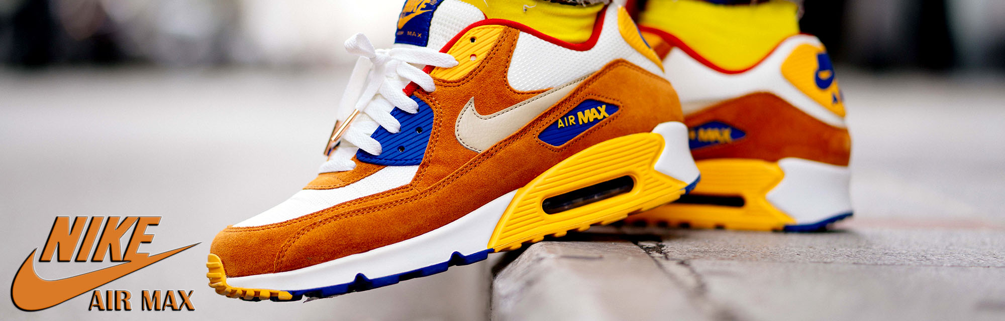Orange Air Max's on a curb